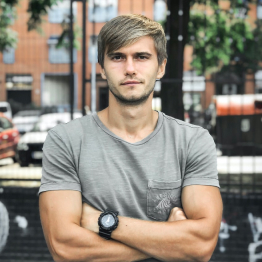 Young blonde man with grey tshirt and black watch